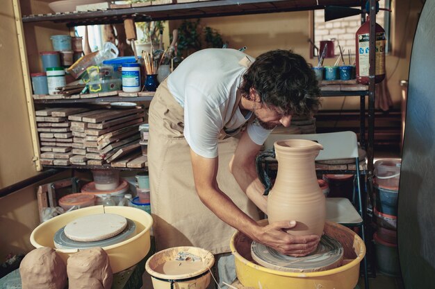 Creación de un primer plano de una jarra o jarrón de arcilla blanca. Maestro olla.