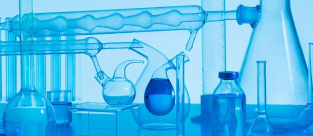 Cristalería de laboratorio y fondo azul.