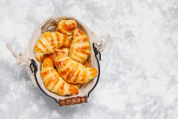 Croissants caseros sabrosos frescos en blanco grisáceo. Pastelería francesa