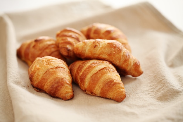 Croissants franceses frescos sobre un mantel