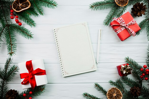 Cuaderno de bocetos cerca de ramita de navidad