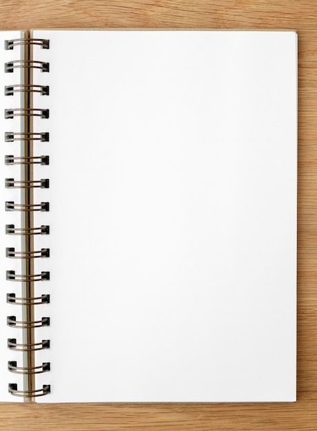 Cuaderno gobernado blanco en blanco sobre una mesa de madera