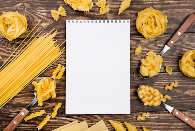 Cuaderno y pasta en cucharas