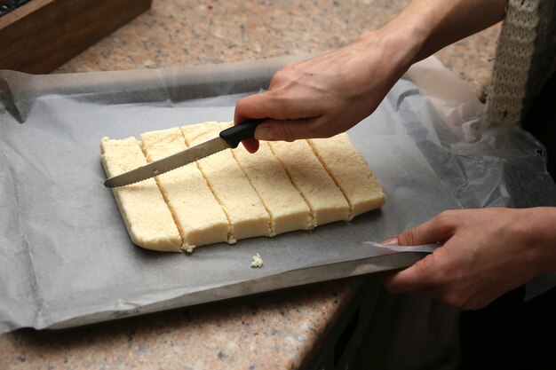 Cuadritos de coco en una bandeja de horno que eventualmente se cubrirán de chocolate.