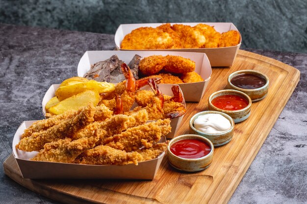 Cuatro cajas de nuggets con queso de pollo con gambas y pescado con cuatro salsas