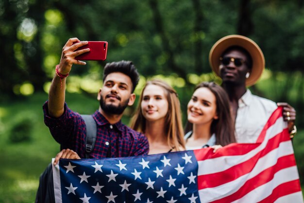 Cuatro estudiantes hacen selfie cerca del campus de la universidad.