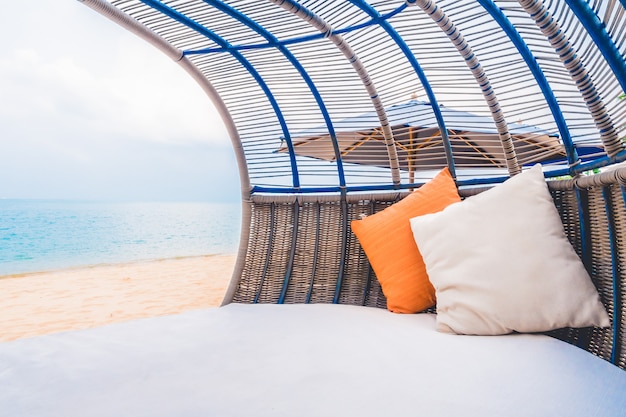 Cubierta de lujo con almohada en la playa y el mar.