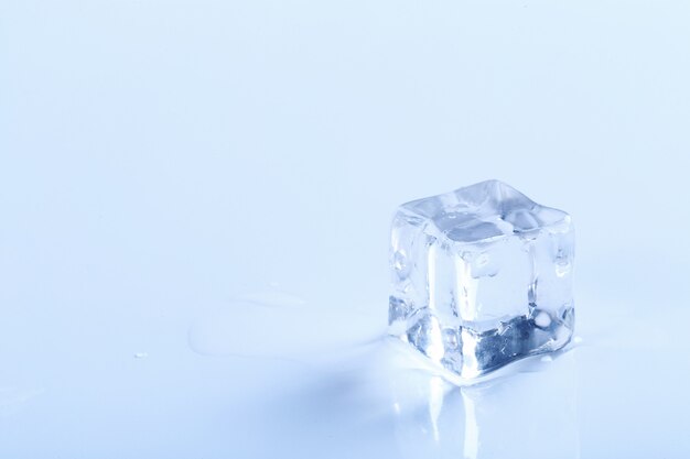 Cubito de hielo sobre superficie blanca