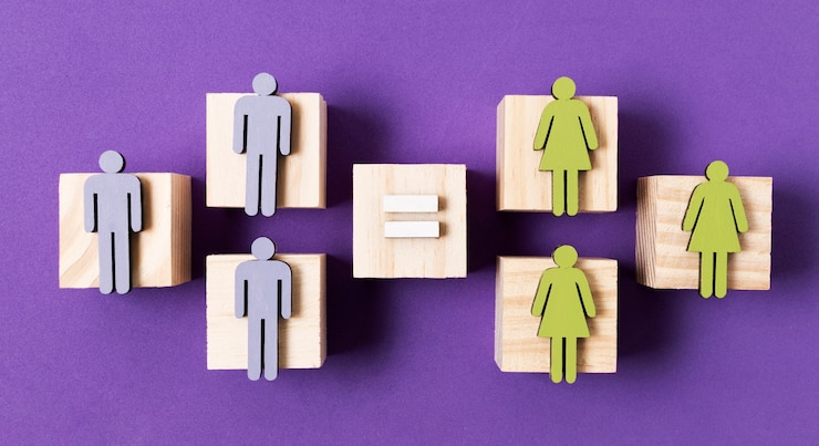 Foto gratuito cubos de madera con mujeres verdes y hombres azules figurillas igualdad concepto vista superior