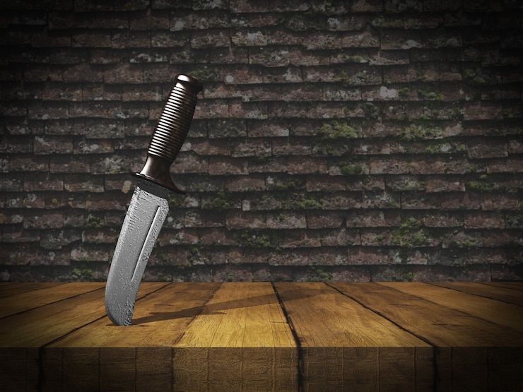Foto gratuito cuchillo 3d atrapado en la mesa de madera contra la pared de ladrillo del grunge