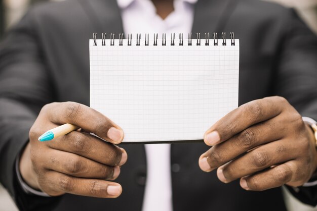 Cultivo hombre sosteniendo cuaderno vacío