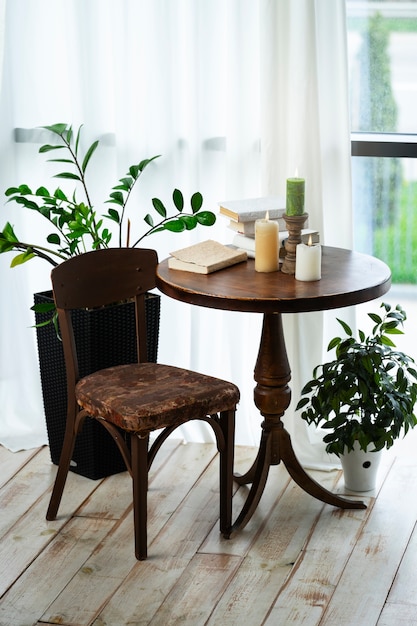 Decoración de la habitación con plantas en macetas y velas en la mesa de madera.