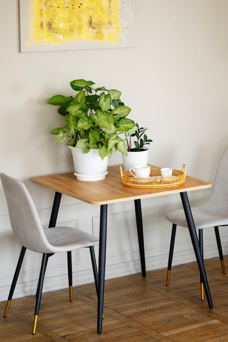 Foto gratuito decoración interior con planta en olla y mesa