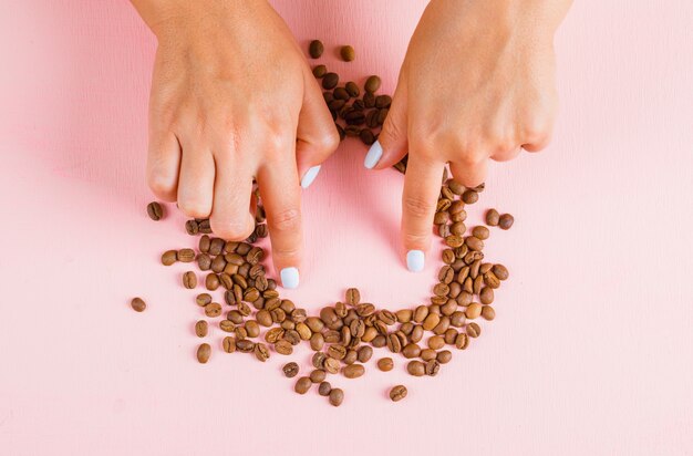 Dedos que separan el corazón de los granos de café