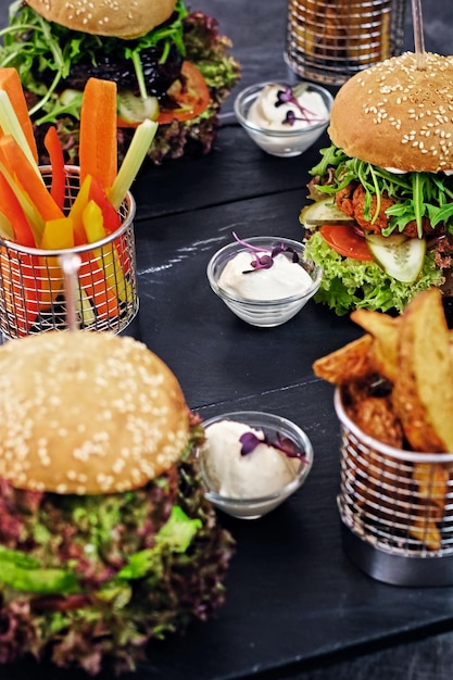 Deliciosa hamburguesa, papas fritas con ensalada en una mesa.