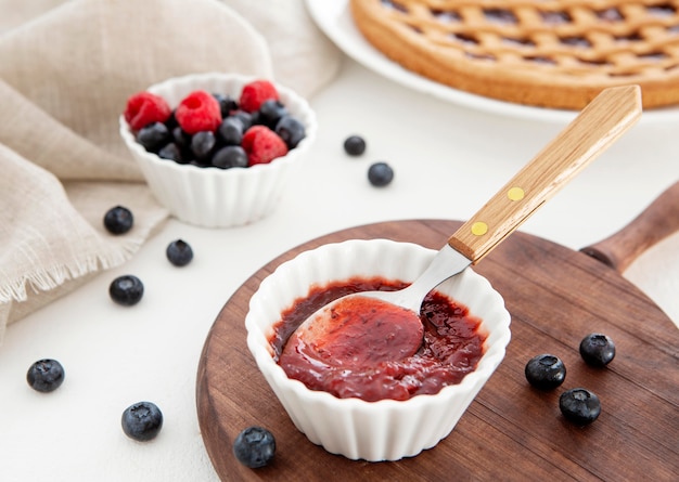 Deliciosa mermelada de frutos del bosque con cuchara para pastel