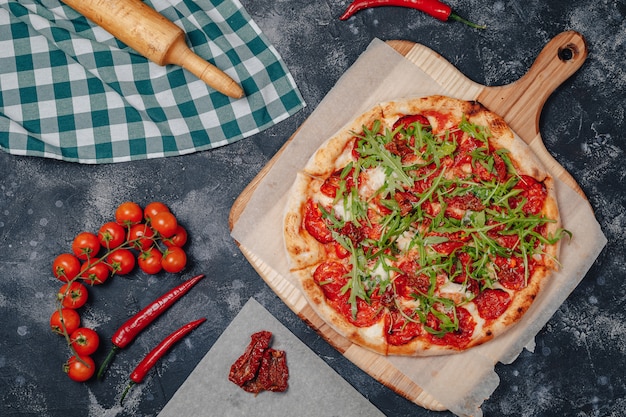 Foto gratuita deliciosa pizza napolitana en un tablero