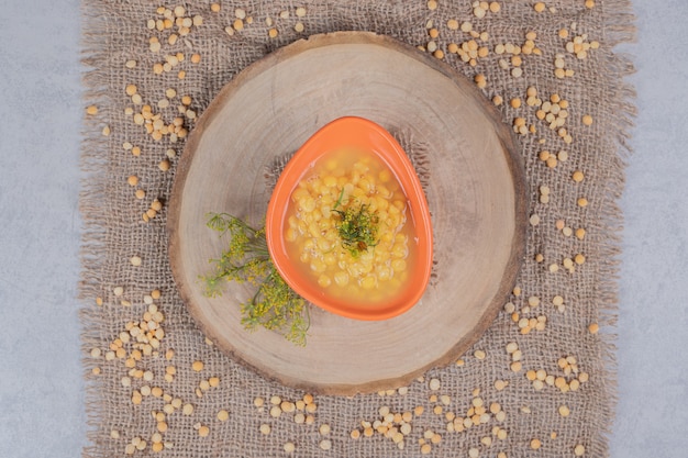 Deliciosa sopa de lentejas con grano de lentejas en placa de madera. Foto de alta calidad