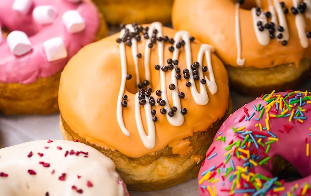 Deliciosas donas de diferentes sabores en papel de cerca