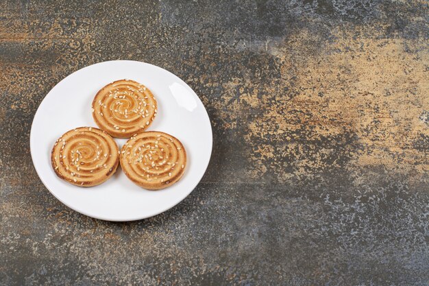 Deliciosas galletas de semillas de sésamo en un plato blanco.