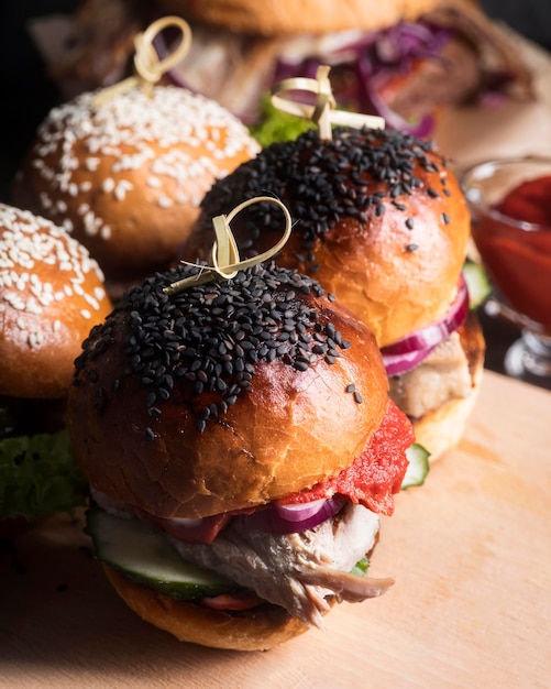 Deliciosas hamburguesas en primer plano de tablero de madera