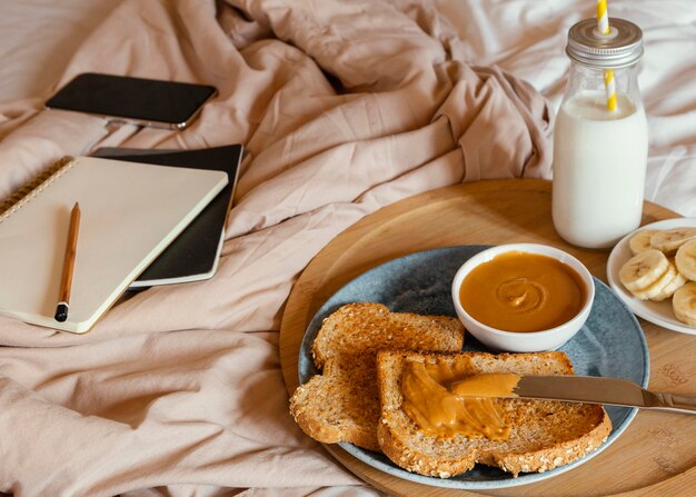 Delicioso desayuno de alto ángulo en la cama