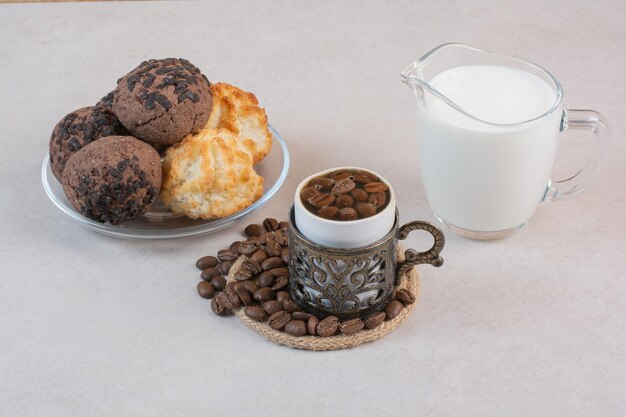 Delicioso vaso de leche fresca con galletas y velas. Foto de alta calidad