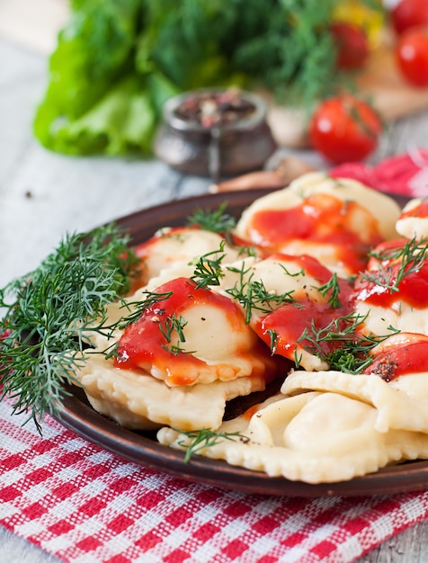 Foto gratuita deliciosos ravioles con salsa de tomate y eneldo