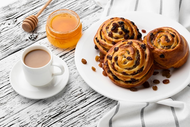 Deliciosos rollos de pasas de canela sobre mesa de madera