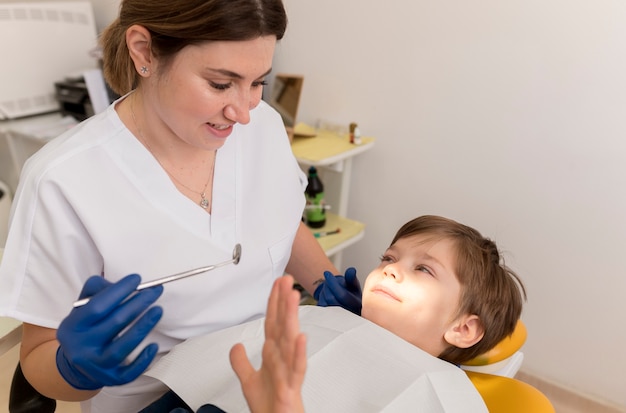 Dentista limpiando los dientes del niño