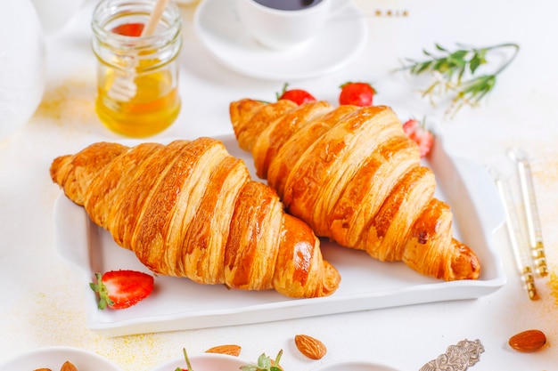 Desayuno con cruasanes recién hechos y una taza de café negro.