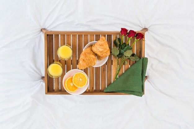 Desayuno romántico en bandeja de madera.