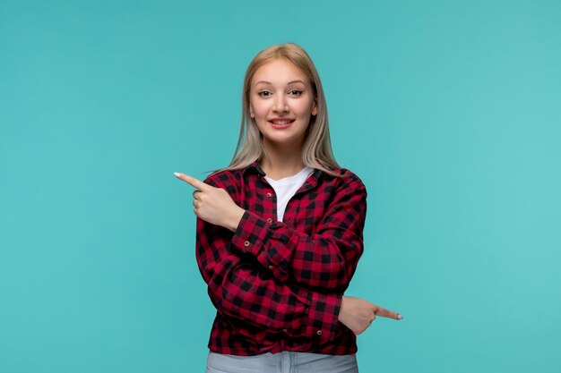 Día internacional de los estudiantes sonriendo encantadora linda chica en camisa roja a cuadros apuntando a diferentes lados