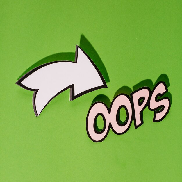Dibujos animados estilo texto oops con signo direccional sobre fondo verde