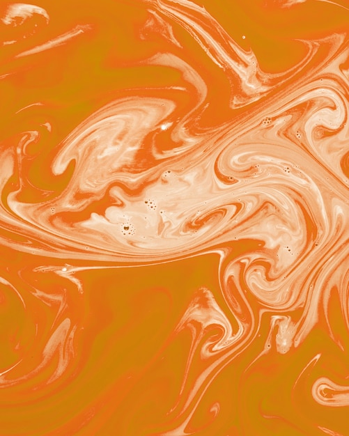 Un diseño de textura de marmoleado naranja y blanco.