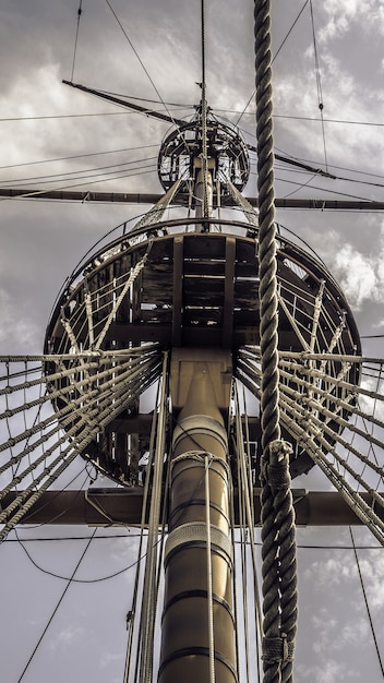 Foto gratuita disparo de ángulo bajo del mástil principal de un barco bajo el cielo nublado