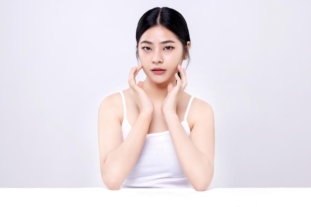 Disparo de estudio de hermosa mujer asiática joven con piel limpia y fresca sobre fondo blanco Cuidado facial Tratamiento facial Cosmetología belleza y spa
