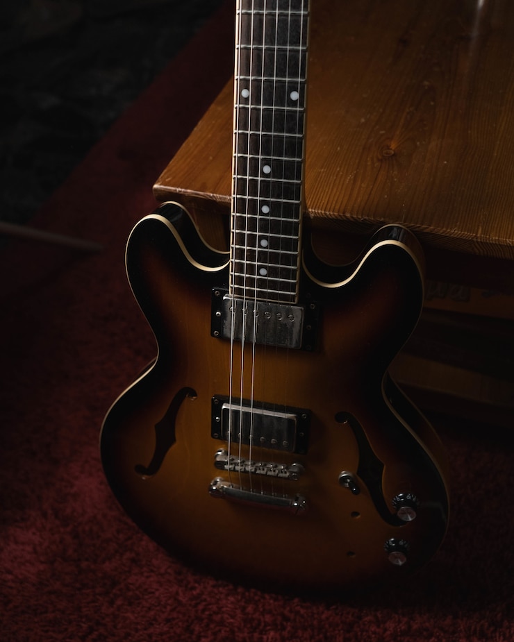 Foto gratuito disparo vertical de una guitarra acústica marrón en el suelo