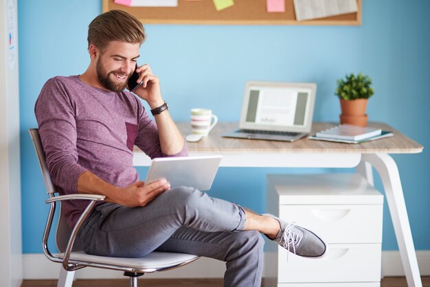 Dispositivos digitales utilizados por hombre joven y alegre.