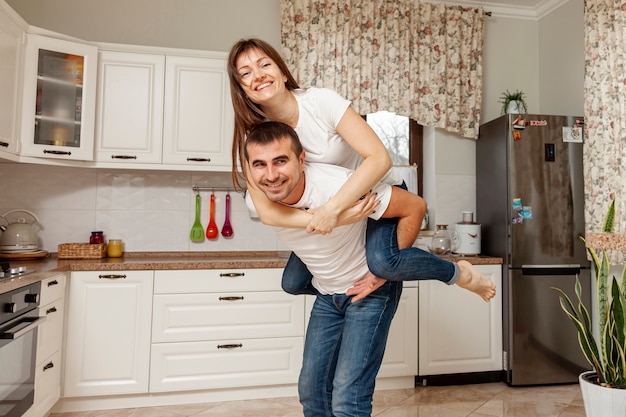 Divertida pareja posando en la cocina
