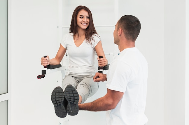 Doctor masculino levantando las piernas del paciente