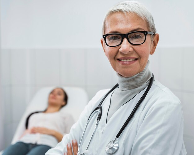 Doctor sonriente posando junto al paciente