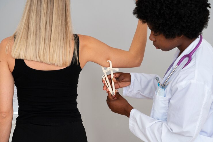 Foto gratuito doctor de tiro medio usando adipómetro