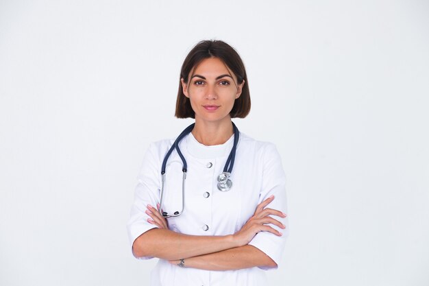 Doctora en bata de laboratorio en blanco aislado, sonrisa confiada