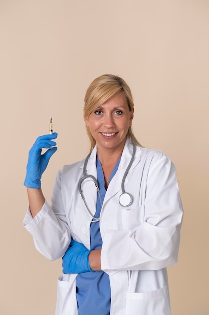 Foto gratuita doctora sonriente sosteniendo una jeringa de vacuna