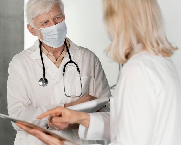 Doctores con máscaras médicas hablando