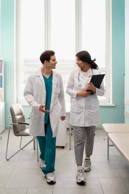 Doctores de tiro completo caminando juntos