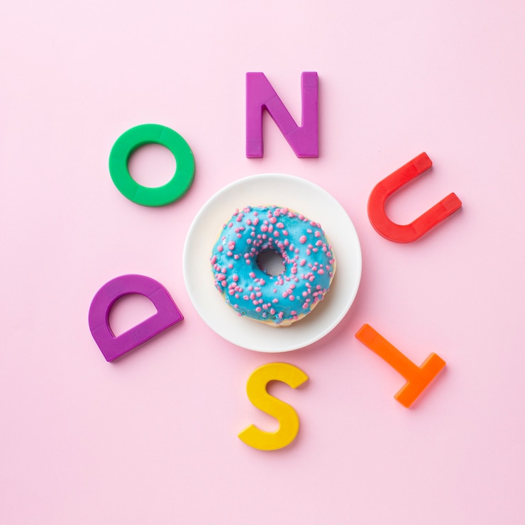Foto gratuito donut rodeado de letras