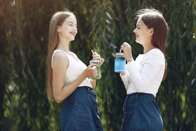 Dos chicas elegantes y con estilo en un parque de primavera