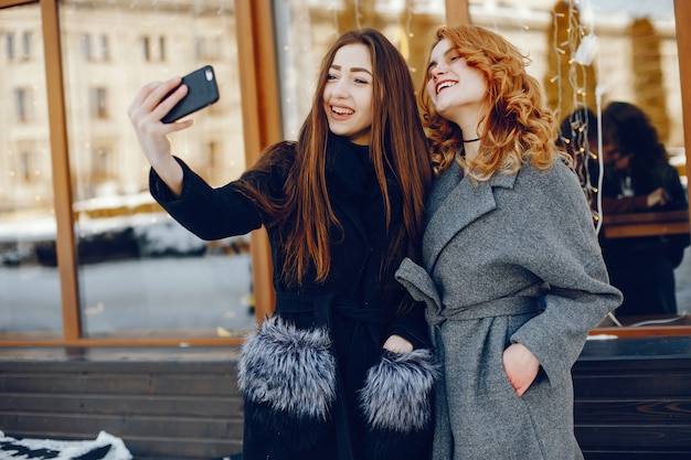 dos chicas guapas en una ciudad de invierno